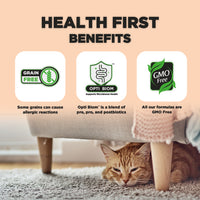 The image highlights the "Health First Benefits" of a pet food product. It includes three main points: "Grain Free" indicating some grains can cause allergic reactions, "Opti Biom" which supports microbiome health and is described as a blend of pre, pro, and postbiotics, and "GMO Free" stating that all formulas are free from genetically modified organisms. At the bottom, a relaxed orange cat is resting under a couch, adding a warm, cozy atmosphere to the scene.