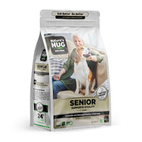 A bag of Senior, Supports Vitality Formula Dog Food for Medium & Large Breeds Nature’s Hug, highlighting support for vitality. The package shows a smiling older woman with a beagle, indicating companionship. The text emphasizes "Complete and Balanced Food for Adult Dogs" and specifies suitability for medium and large breeds.